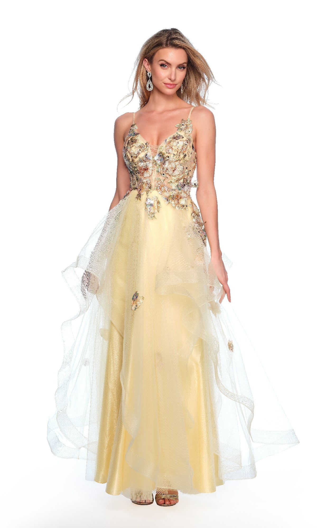 A woman models the Dave & Johnny 11859 long yellow prom dress, featuring floral applique, a deep V-neckline, and a horsehair hem tulle skirt, against a white background.